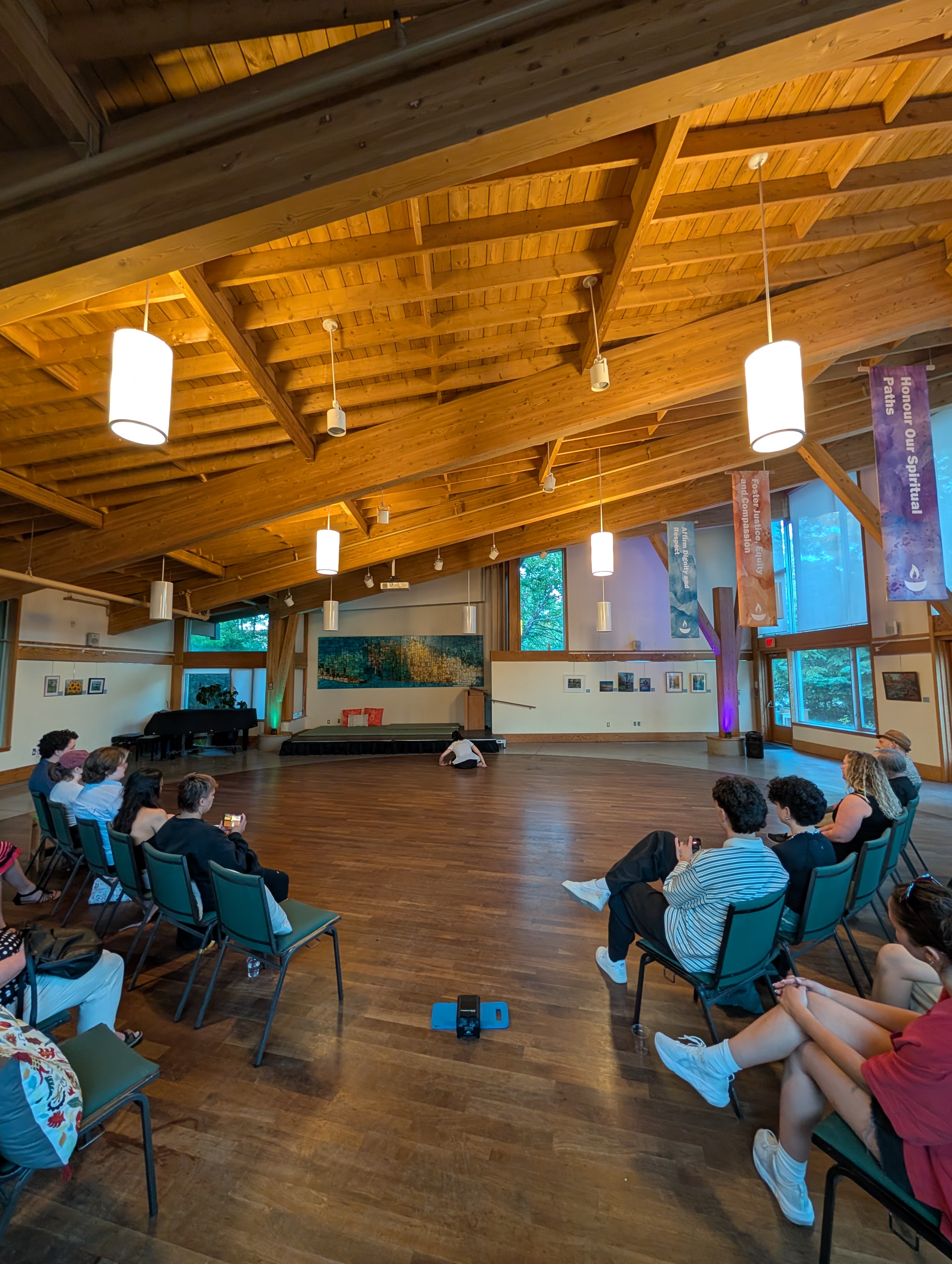 the audience watches Sam perform inside the great hall